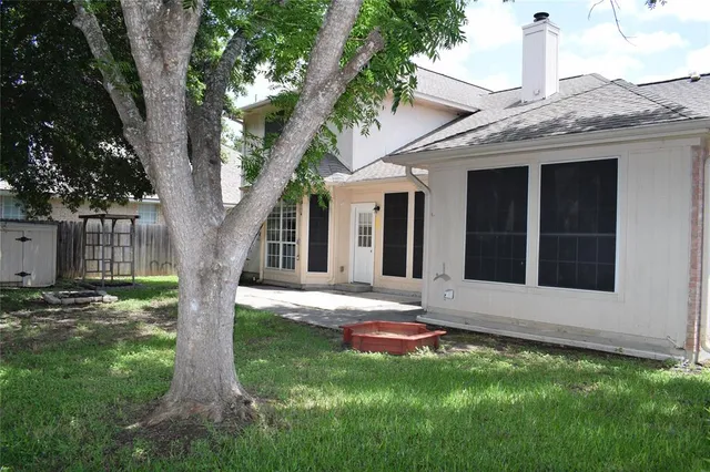 a view of a house with a backyard