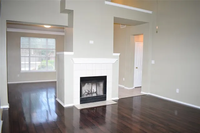 a room with a fireplace and wooden floor