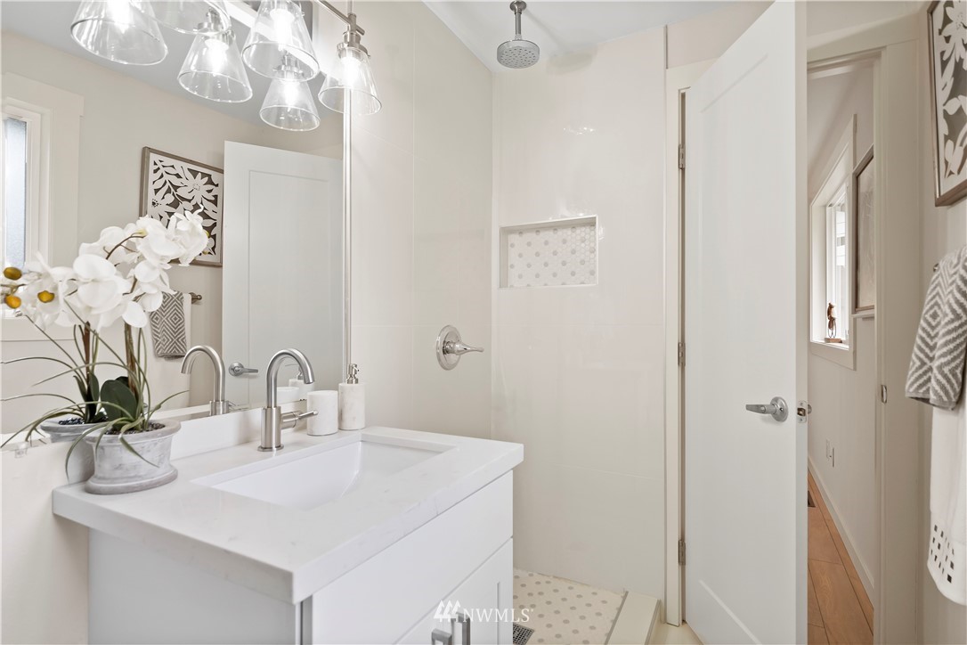 5723 Highland Road Everett, WA 98203 - Photo 13 of 21 a bathroom with a sink a mirror and a shower