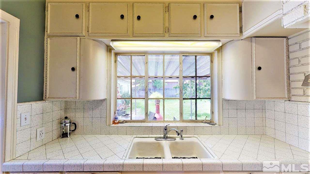 30 Kohlepp Avenue Reno, NV 89509 - Photo 12 of 29 a bathroom with a bathtub a sink and a window
