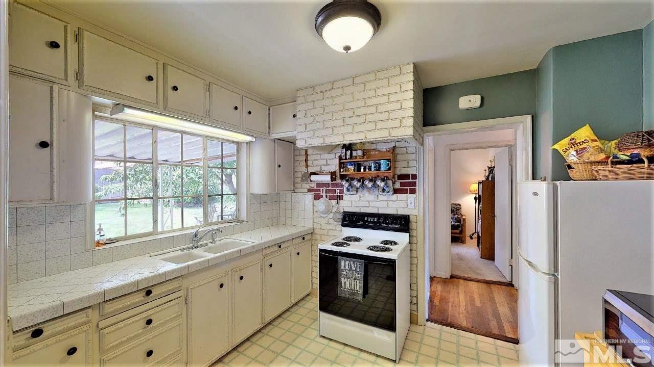 30 Kohlepp Avenue Reno, NV 89509 - Photo 10 of 29 a kitchen with stainless steel appliances granite countertop a refrigerator and a stove top oven