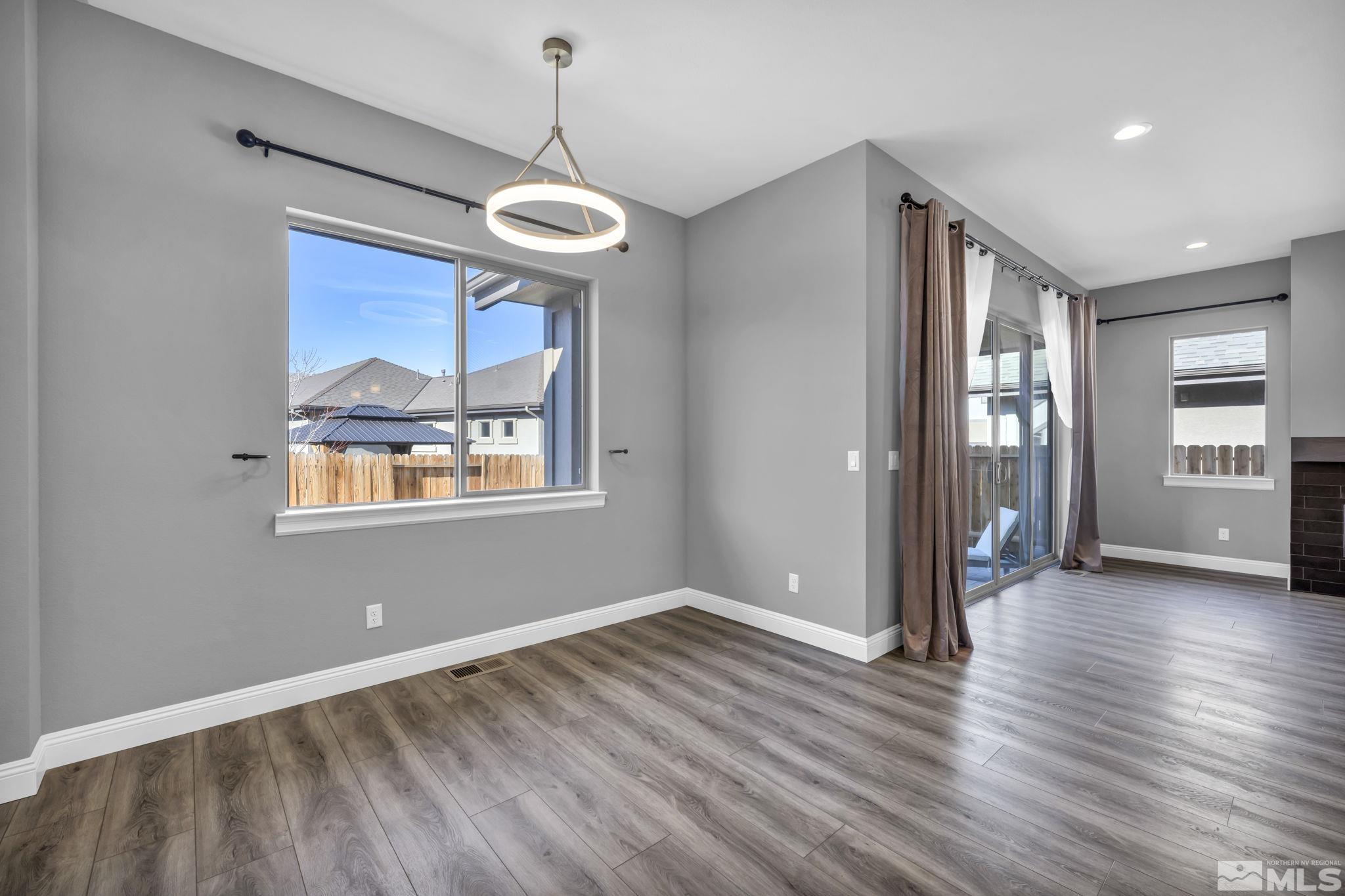 3108 Cambria Loop Carson City, NV 89703 - Photo 13 of 39 a view of an empty room with a window and wooden floor