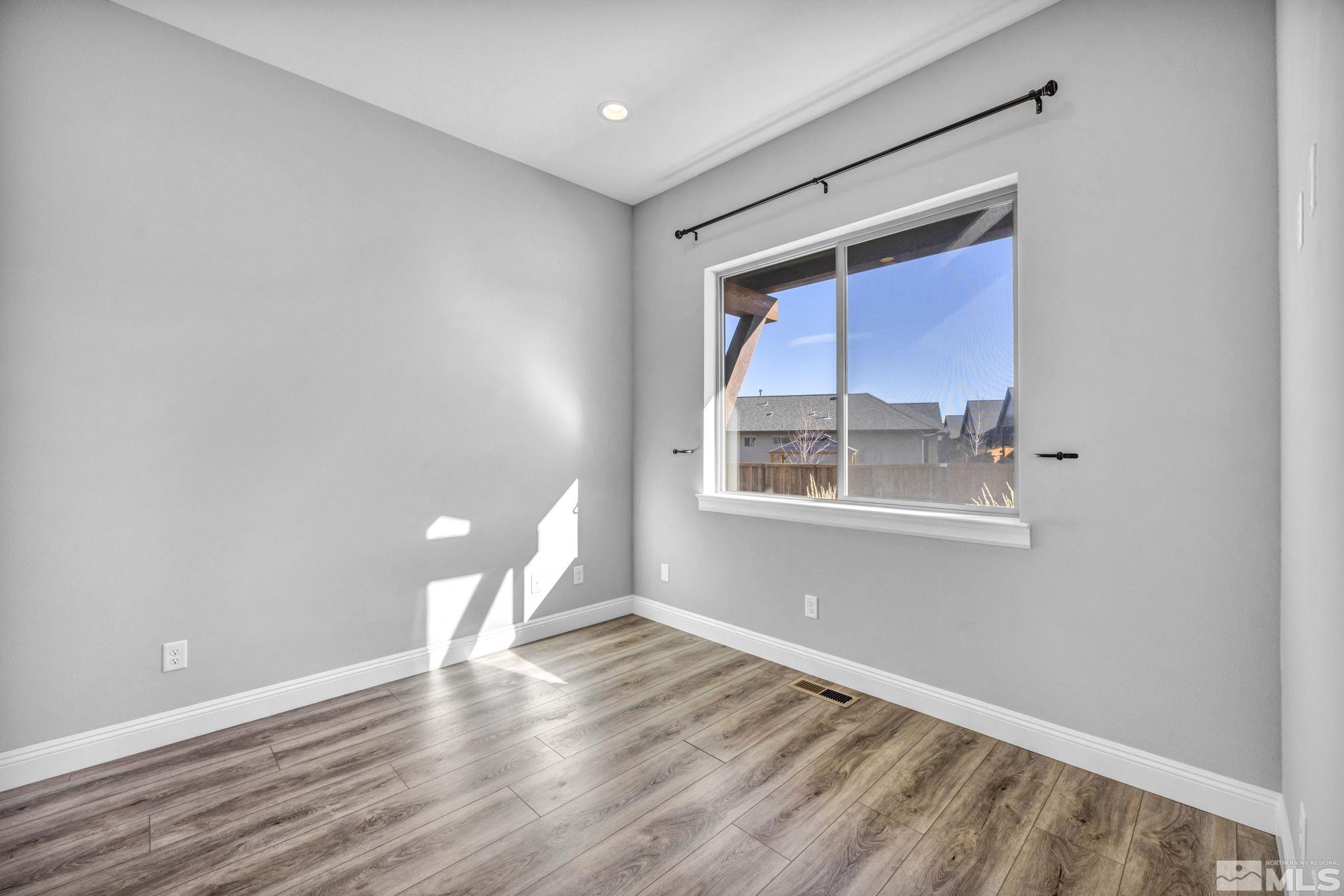 3108 Cambria Loop Carson City, NV 89703 - Photo 18 of 39 a view of an empty room with wooden floor and a window