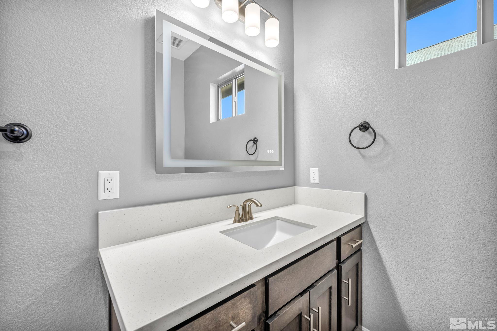 3108 Cambria Loop Carson City, NV 89703 - Photo 20 of 39 a bathroom with a sink vanity and mirror