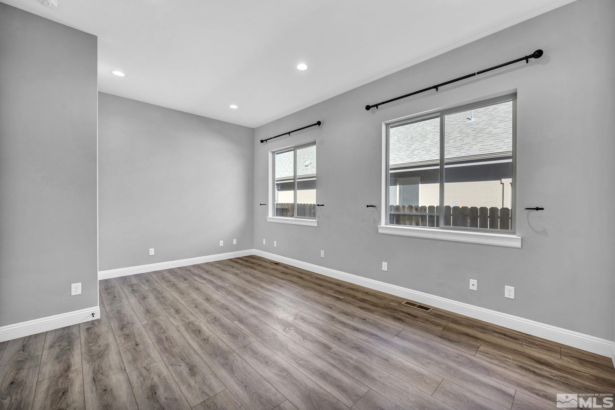 3108 Cambria Loop Carson City, NV 89703 - Photo 21 of 39 a view of an empty room with wooden floor and a window