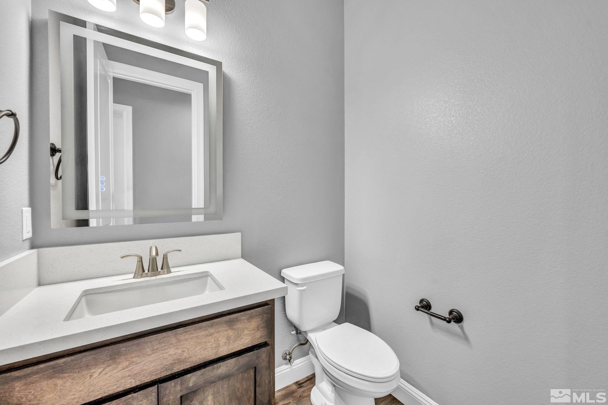 3108 Cambria Loop Carson City, NV 89703 - Photo 24 of 39 a bathroom with a granite countertop sink a toilet and a mirror