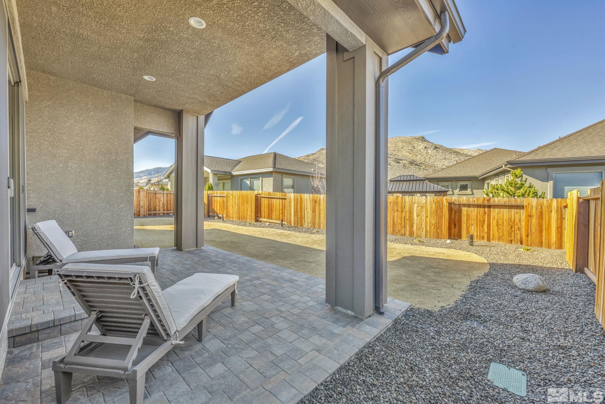 3108 Cambria Loop Carson City, NV 89703 - Photo 33 of 39 a living room with a floor to ceiling window and a table