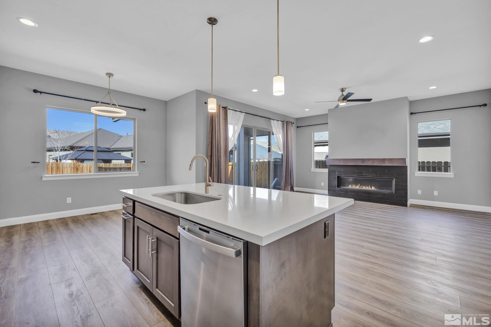 3108 Cambria Loop Carson City, NV 89703 - Photo 6 of 39 a view of kitchen island with wooden floor and windows