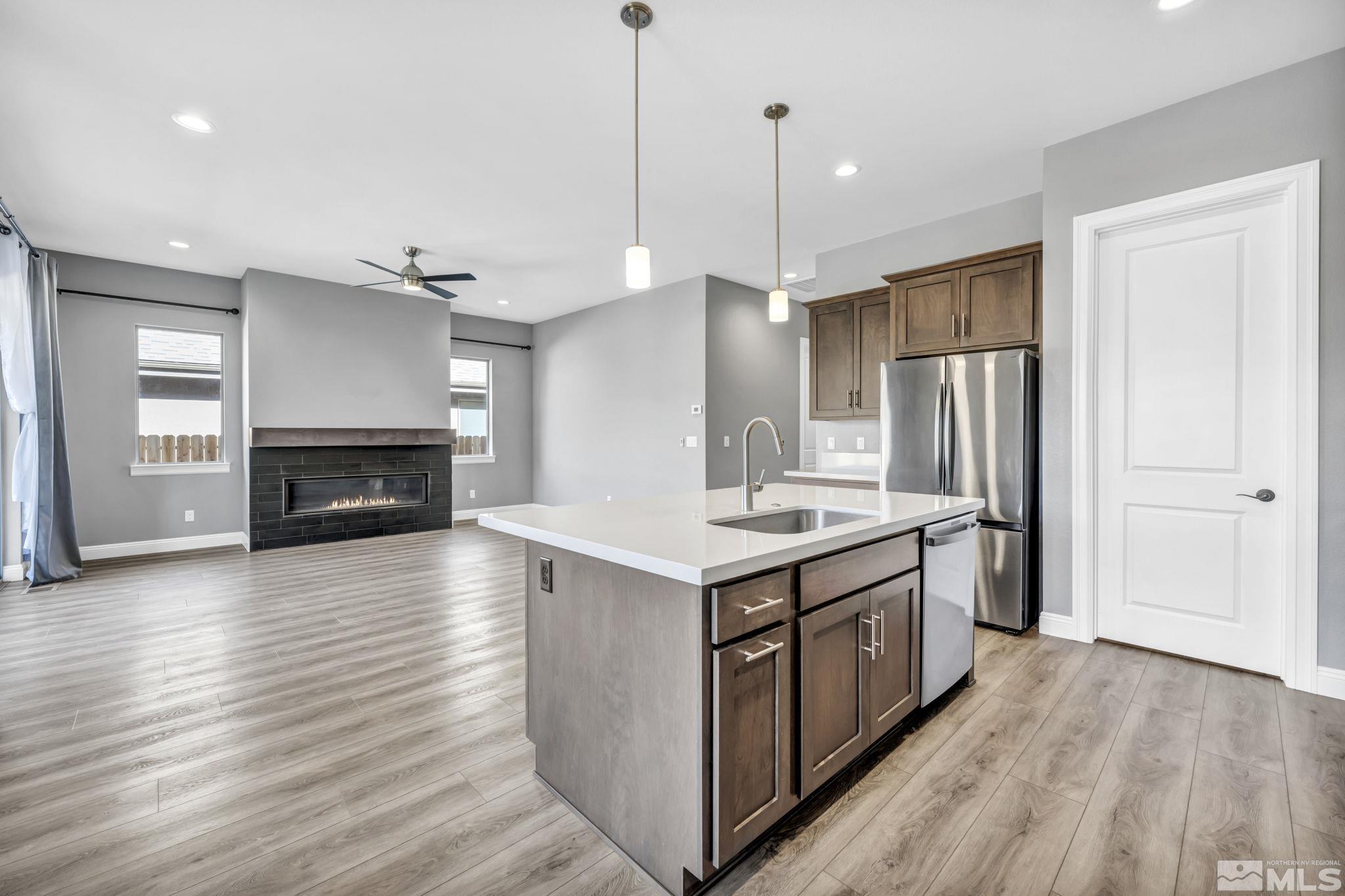 3108 Cambria Loop Carson City, NV 89703 - Photo 7 of 39 a kitchen with stainless steel appliances granite countertop a stove and a refrigerator