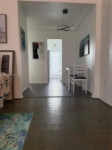 a view of a livingroom with furniture and a flat screen tv