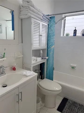 a bathroom with a sink a toilet and a bathtub