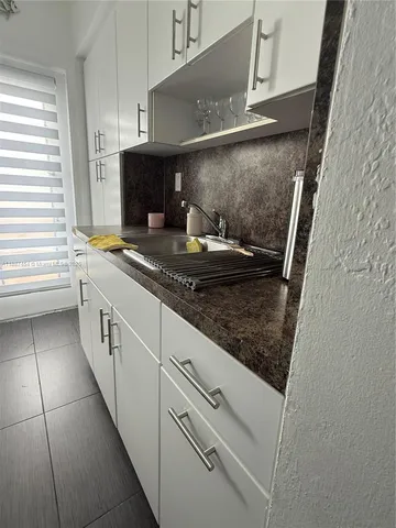 a kitchen with stainless steel appliances granite countertop a sink and a stove