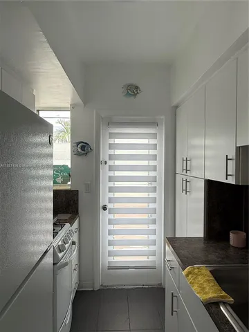 a kitchen with a refrigerator and a stove