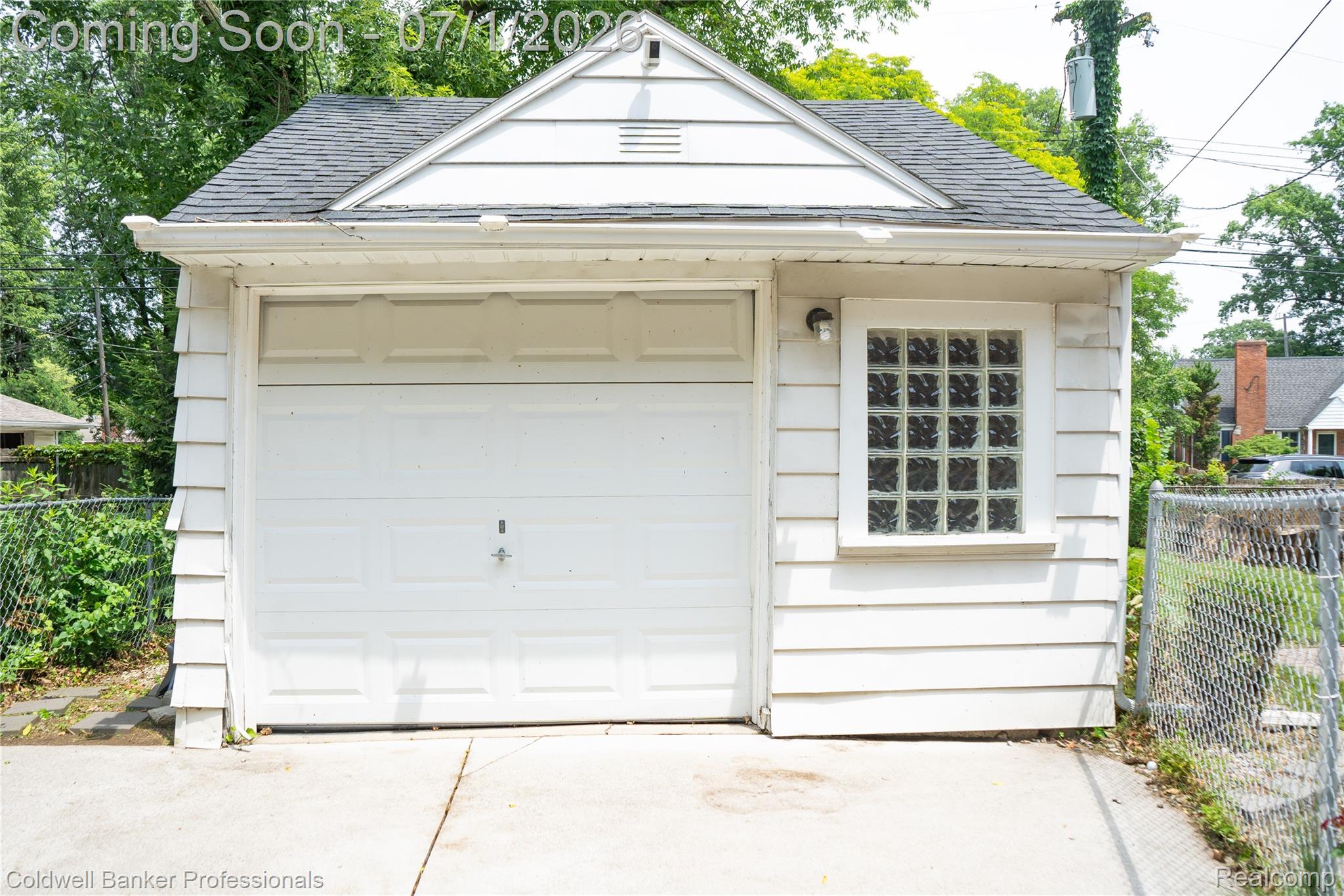 1168 Vernier Road Grosse Pointe, MI 48236 - Photo 4 of 32 Detached garage with white siding, asphalt shingle roof, and a single garage door