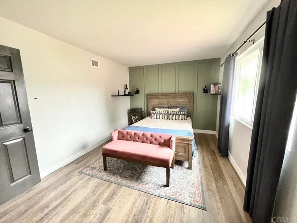 a bed sitting in a bedroom next to a window