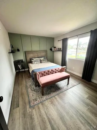 a bedroom with a bed and a large window