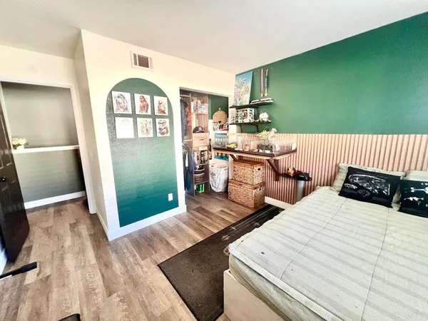 a living room with white furniture and a fireplace