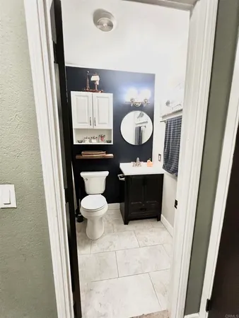 a bathroom with a toilet a sink and a mirror