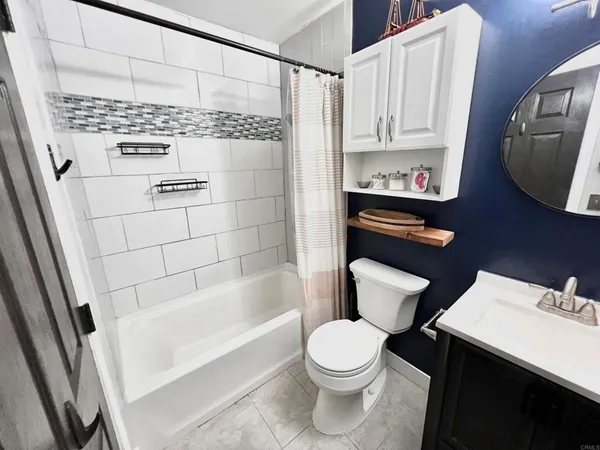 a bathroom with a toilet a sink and bathtub