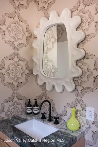 a bathroom with a sink and a mirror