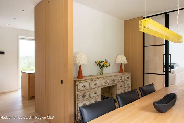 a dining room with furniture and wooden floor
