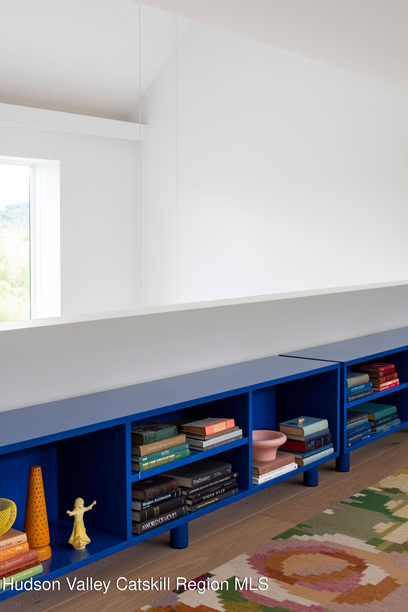 78 Waldorf Ridge Road Copake, NY 12516 - Photo 35 of 50 a living room with furniture and a book shelf