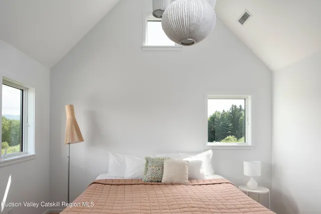 a bedroom with a bed and a painting on the wall