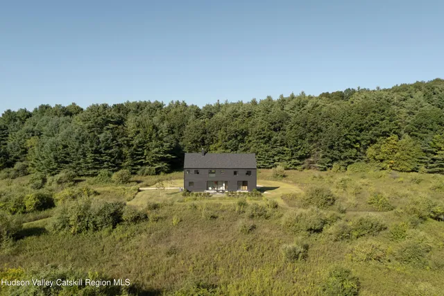 a view of a big yard with large trees