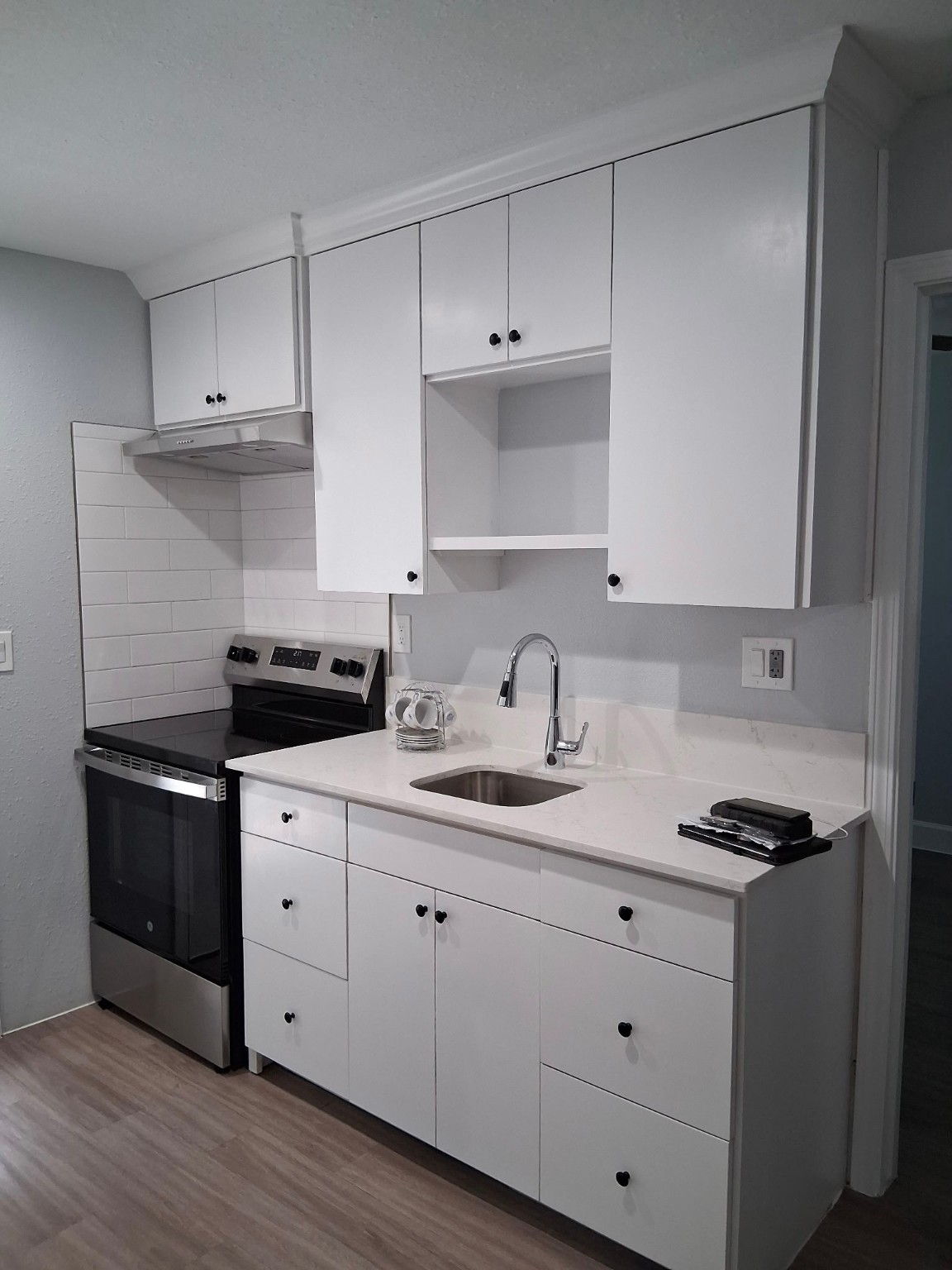 a kitchen with cabinets appliances and a sink