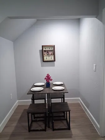 a view of a room with furniture and wooden floor