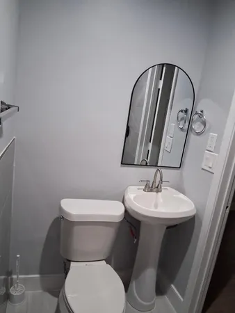 a white toilet sitting next to a bathroom sink