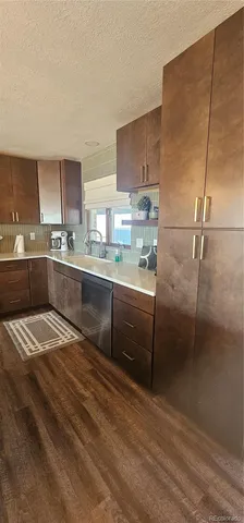 a kitchen with stainless steel appliances granite countertop a sink refrigerator and cabinets