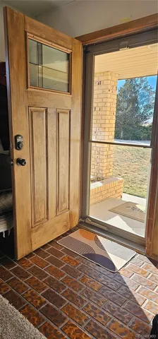 a view of a room that has a window and wooden floor