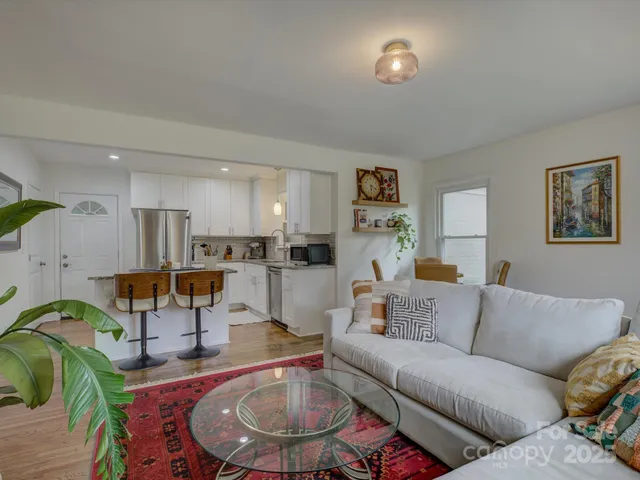 a living room with furniture kitchen view and a table