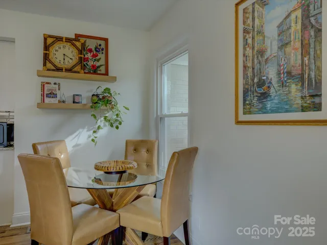 a view of a dining room with furniture and a potted plant