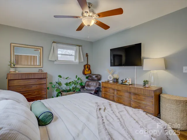 a bedroom with a bed and a flat screen tv