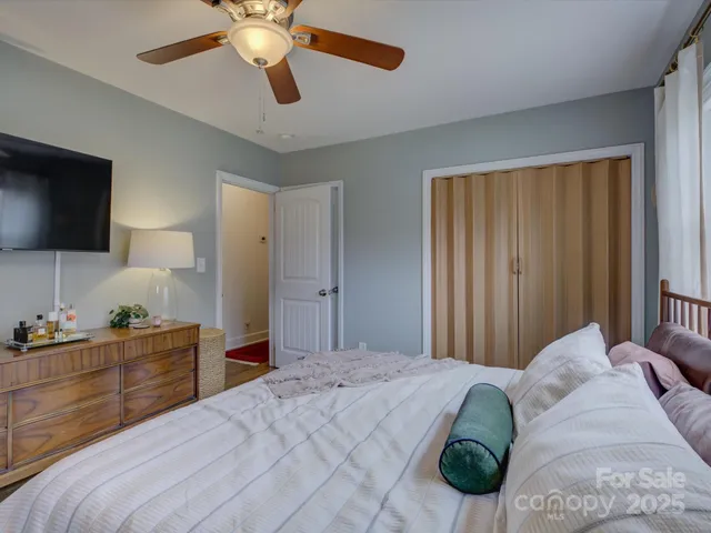 a bedroom with a bed and a chandelier