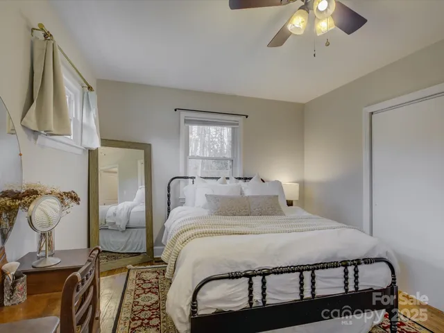 a bedroom with a bed and ceiling fan