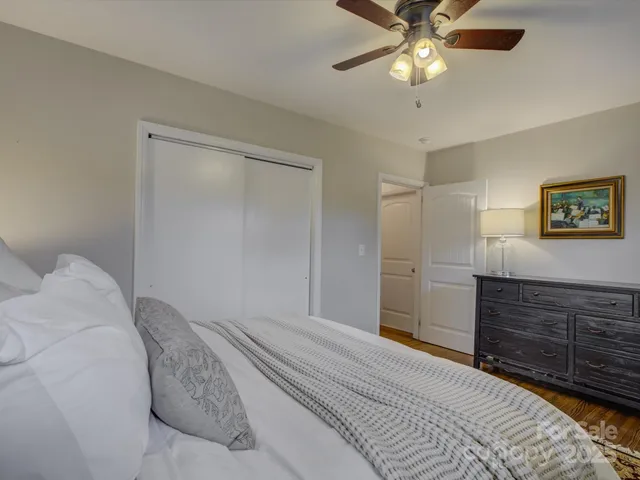 a bedroom with a bed and a chandelier