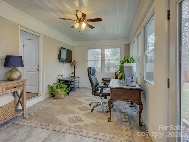 a workspace with wooden floor and a window