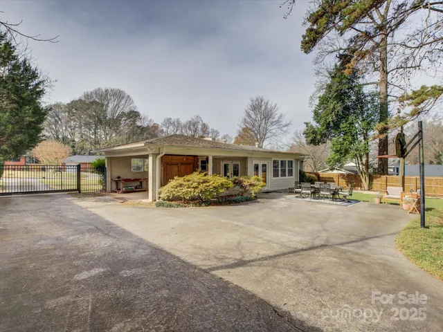 a front view of a house with a garden and tree