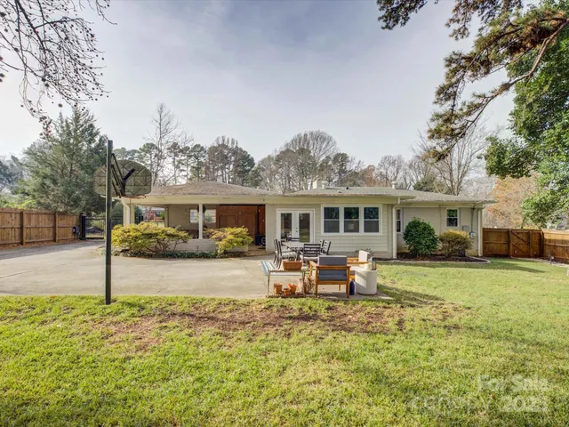 a front view of house with yard seating and green space