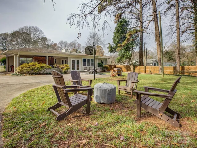 a view of a house with backyard sitting area and garden