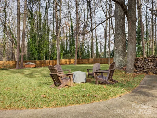 a backyard of a house with table and chairs