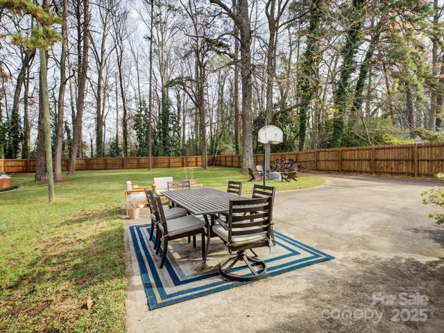 a view of a backyard with sitting area