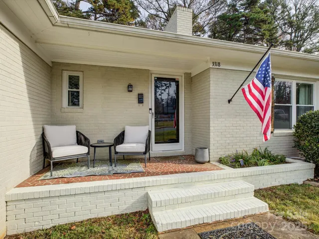 a building outdoor space with patio furniture and potted plants
