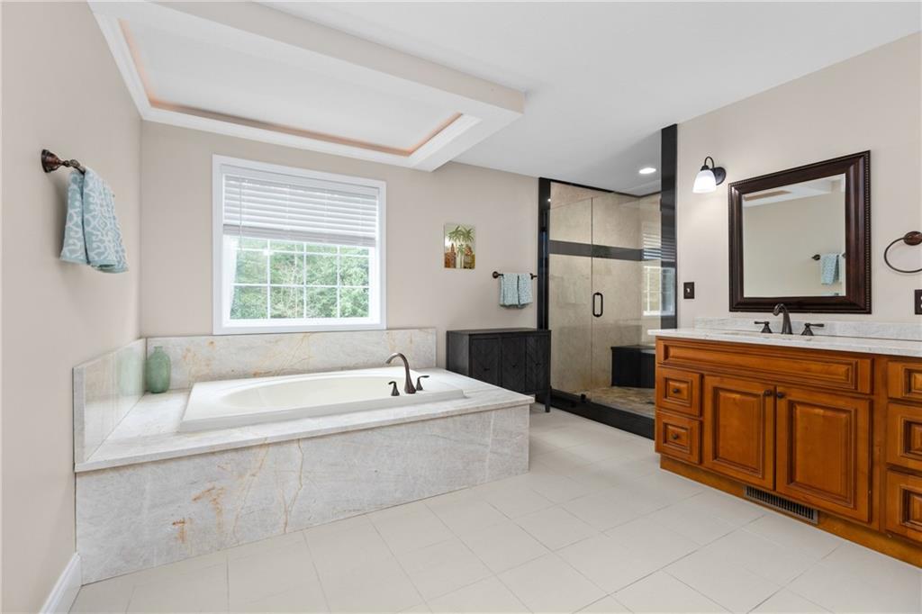 158 Hammond Road Mars, PA 16046 - Photo 23 of 49 a spacious bathroom with double vanity a mirror a bathtub and a sink