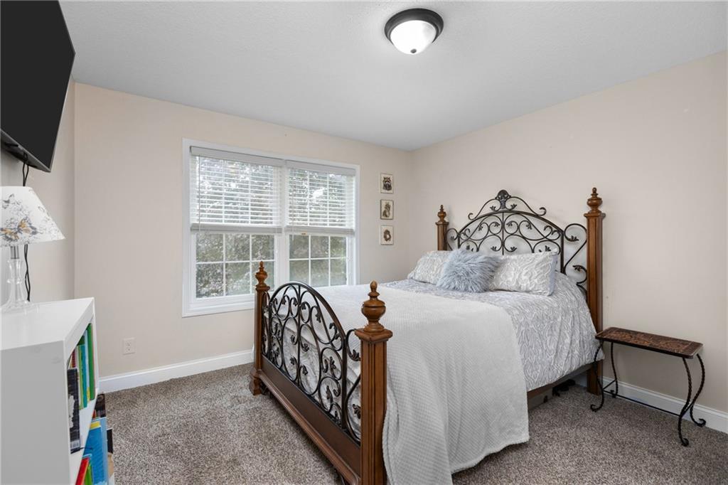 158 Hammond Road Mars, PA 16046 - Photo 24 of 49 a bedroom with a bed and a flat tv screen on the wall