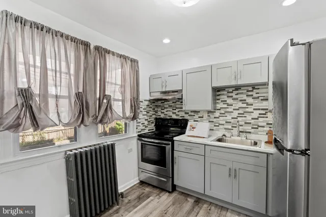 a kitchen with a refrigerator and a stove
