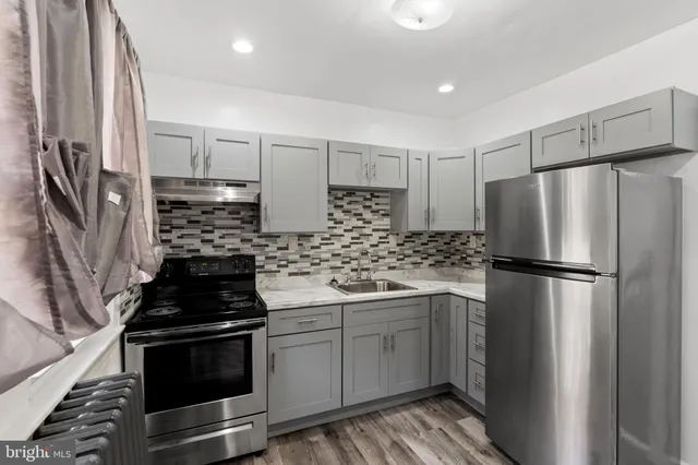 a kitchen with a sink stove and refrigerator